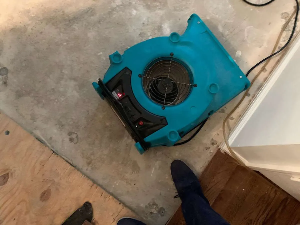 Air mover drying subfloor during Leak Detection & Repair in Fair Lakes